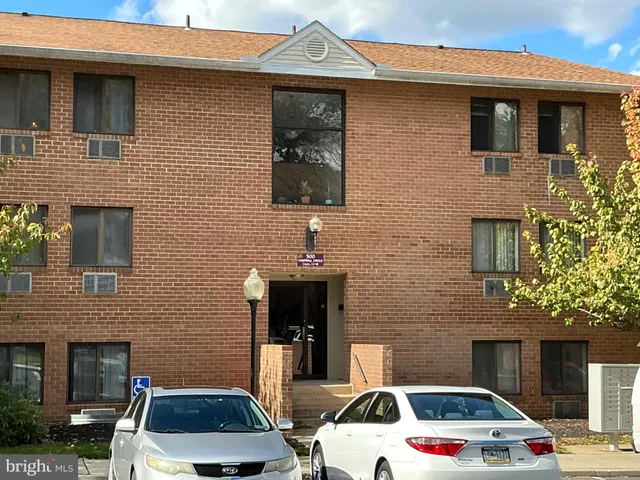 a front view of a house with parking space
