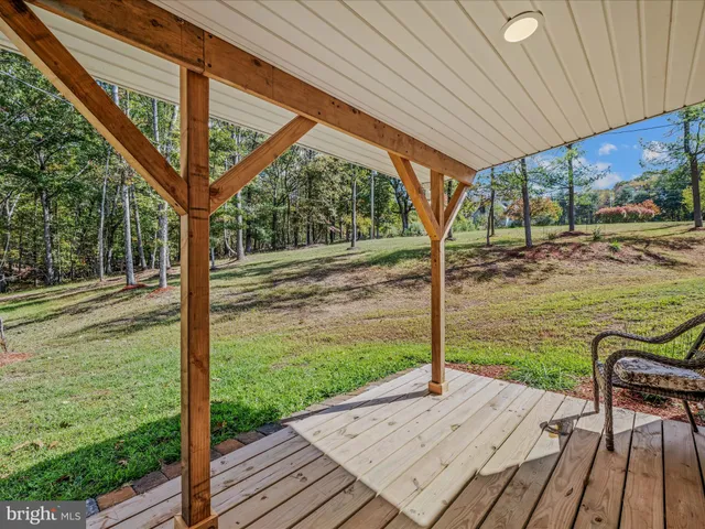 a view of a wooden deck with a yard