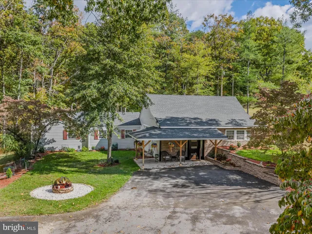 a view of a house with a yard and a tree