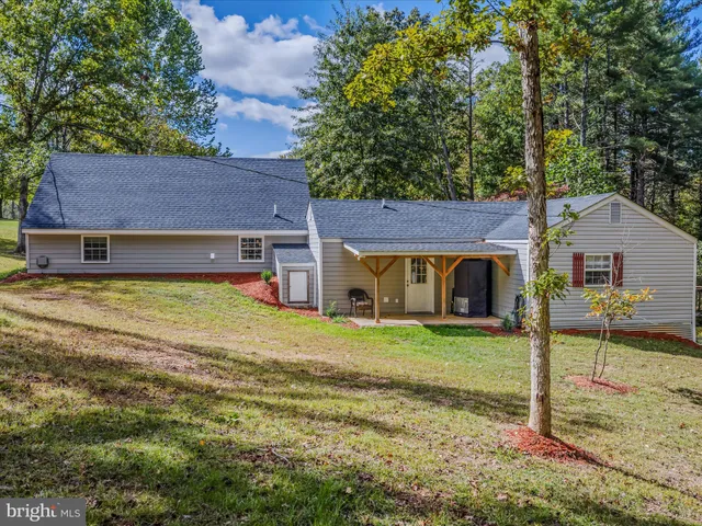 a house view with a sitting space and garden