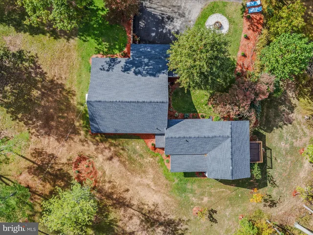 an aerial view of a house with a yard