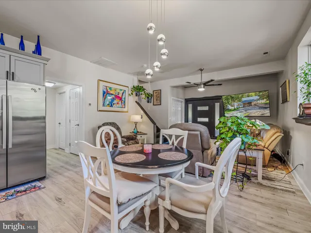 a dining room with furniture a rug and wooden floor
