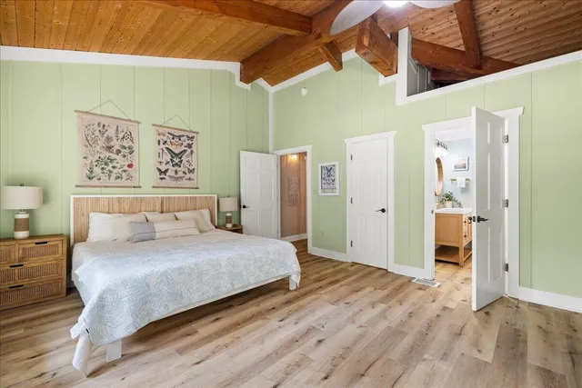 a bedroom with a large bed and a table