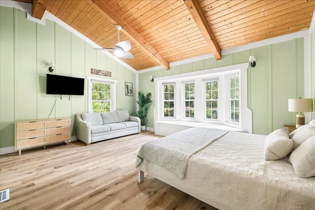 a bedroom with a large bed and a flat screen tv