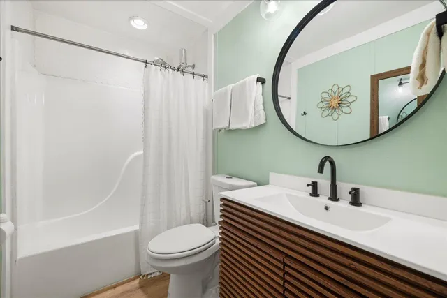 a bathroom with a sink a toilet and a mirror