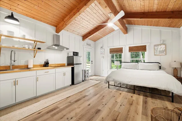 a spacious bedroom with a large bed and a large window