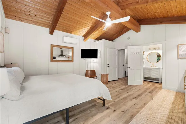 a bedroom with a large bed and a flat screen tv