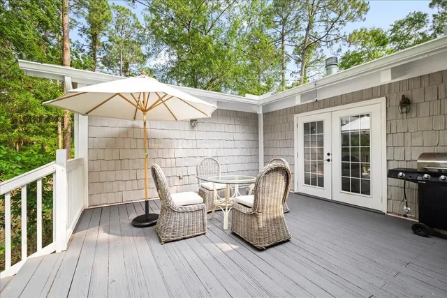 a view of a roof deck with table and chairs and wooden floor