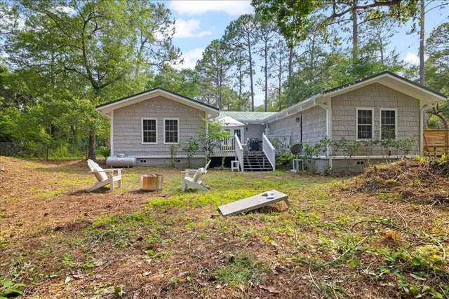 a view of a house with pool and chairs