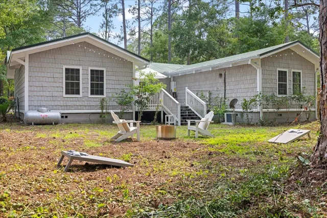 a view of a house with backyard and sitting area