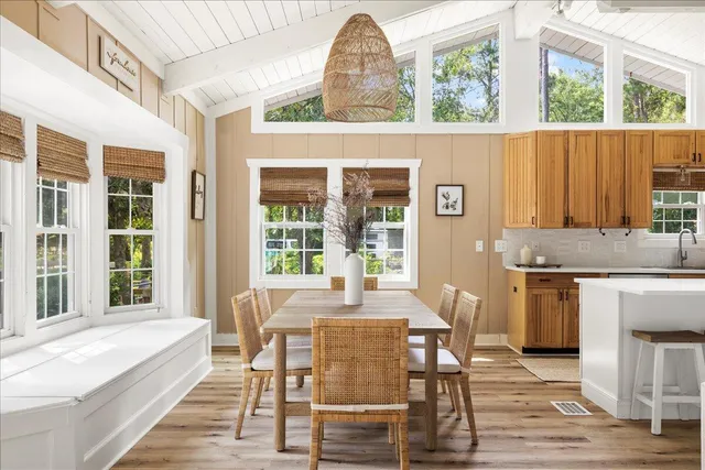 a dining room with a window and chairs