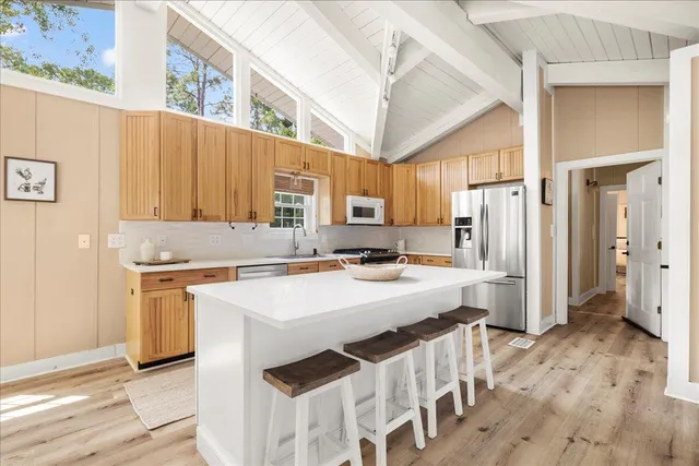 a kitchen with stainless steel appliances a stove refrigerator sink and cabinets