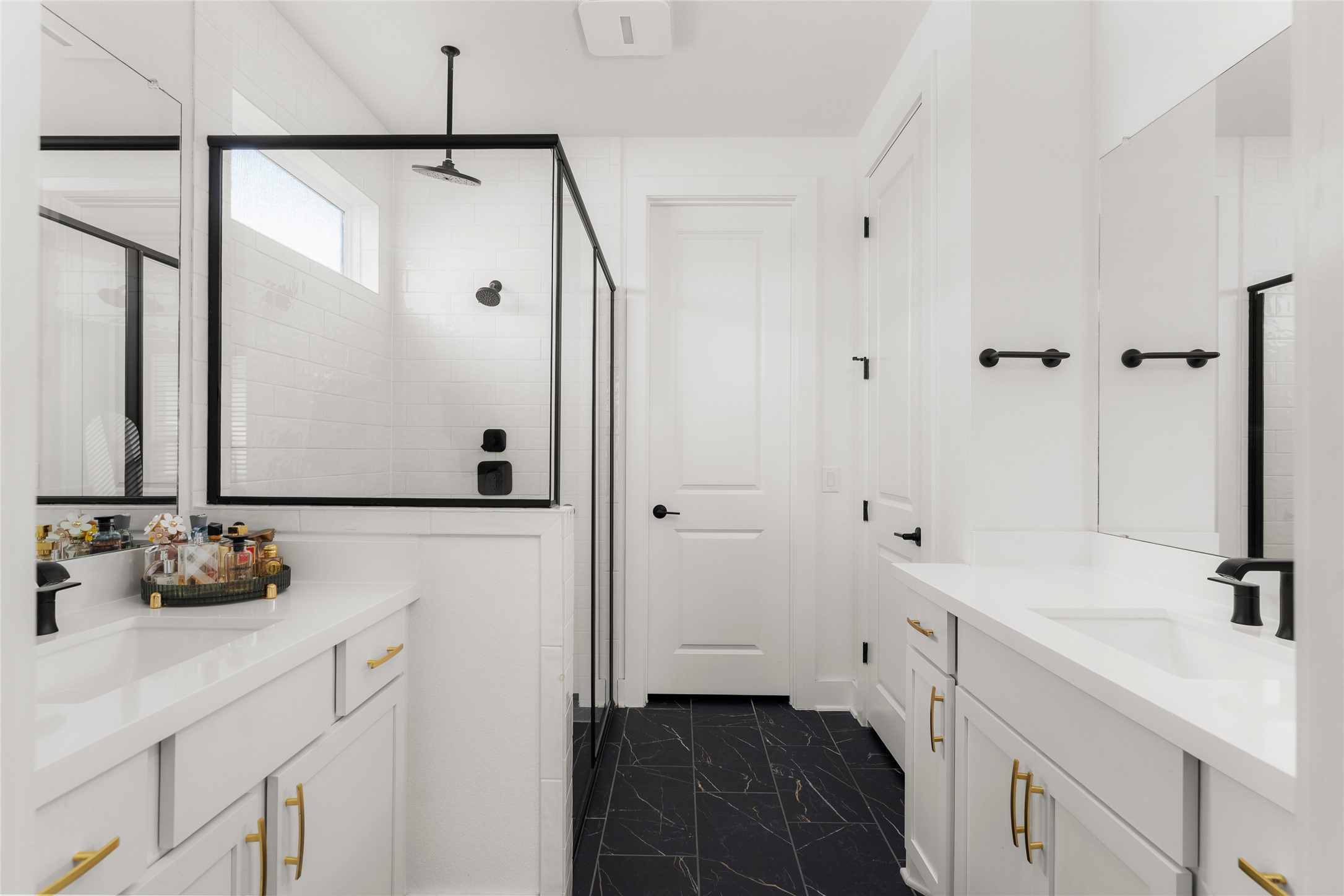 7917 Edmondson Bend Austin, TX 78744 - Photo 10 of 24 Contemporary bathroom featuring a spacious shower with black-framed glass enclosure, subway tile surround, and black fixtures