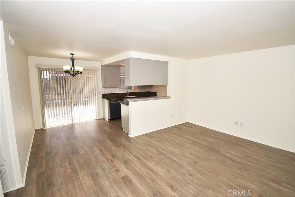 9872 Highland Avenue, Unit B Rancho Cucamonga, CA 91737 - Photo 4 of 16 a view of a kitchen with wooden floor and a sink