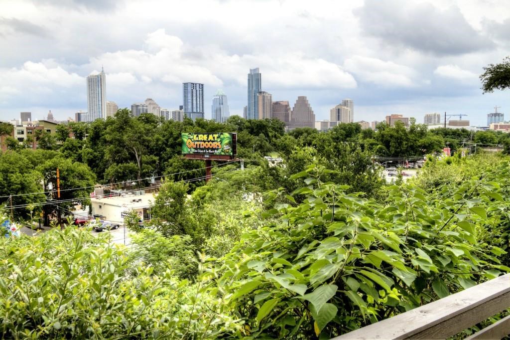 a view of a city with lush green forest