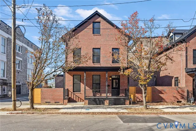 a view of a house with a tree in front of it