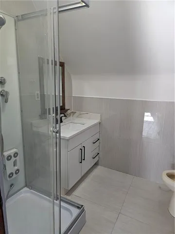 a bathroom with a sink toilet and shower