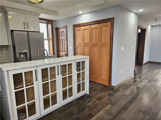 a view of a refrigerator in kitchen and wooden floor