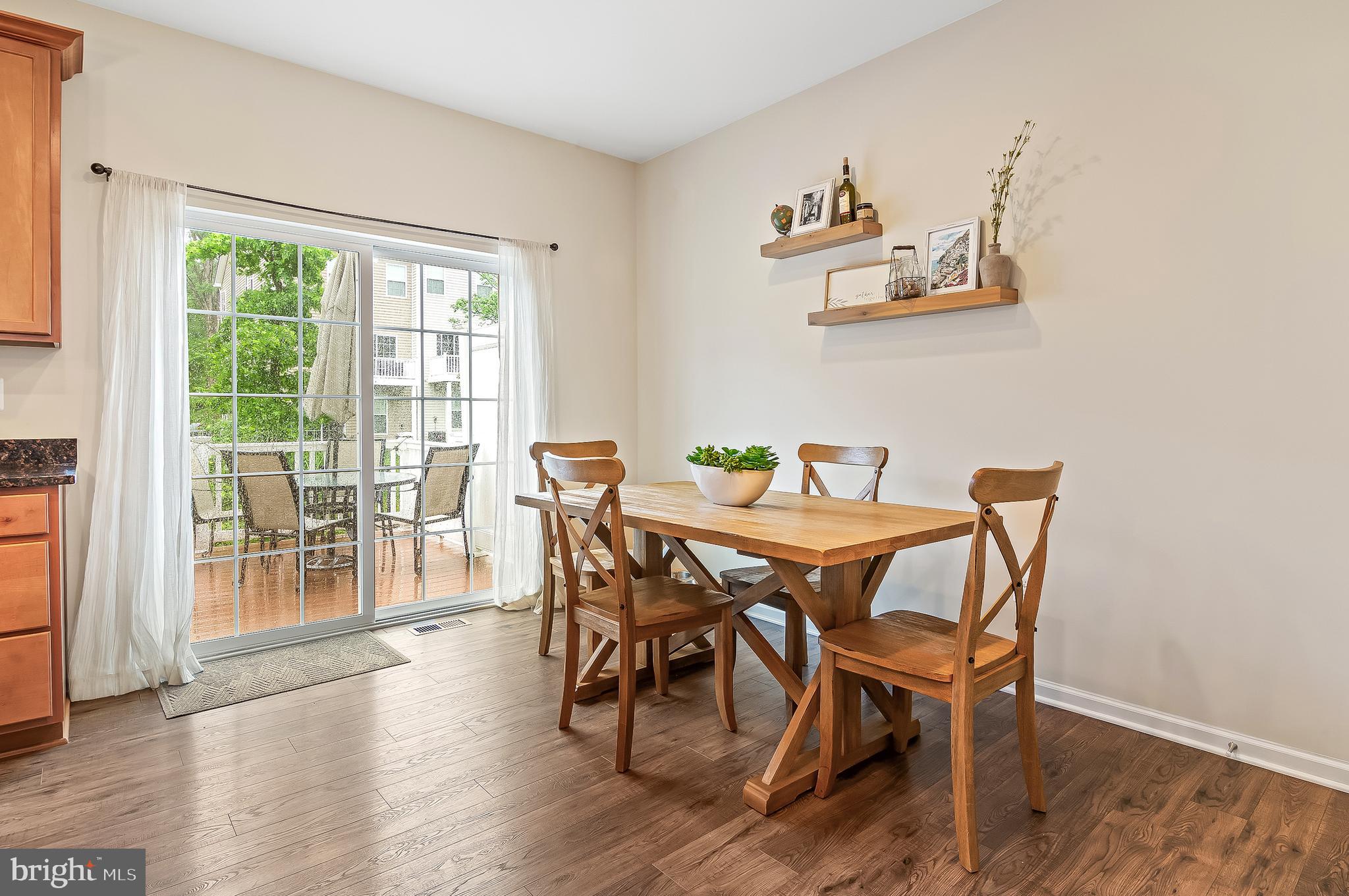 1022 Linden Drive Hanover, MD 21076 - Photo 19 of 42 a view of a dining room with furniture wooden floor and a potted plant