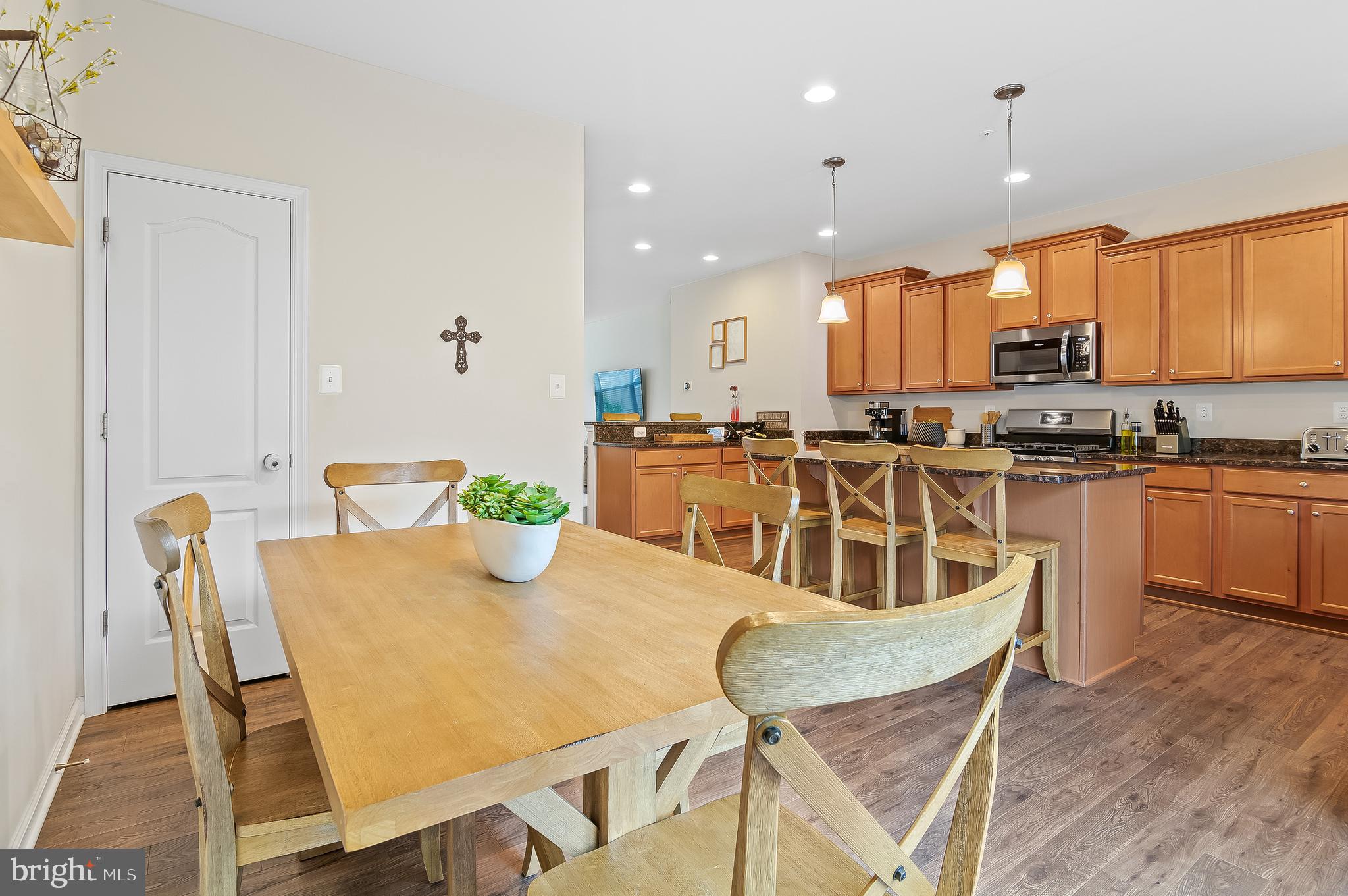 1022 Linden Drive Hanover, MD 21076 - Photo 20 of 42 a view of a dining room with furniture a kitchen and chandelier