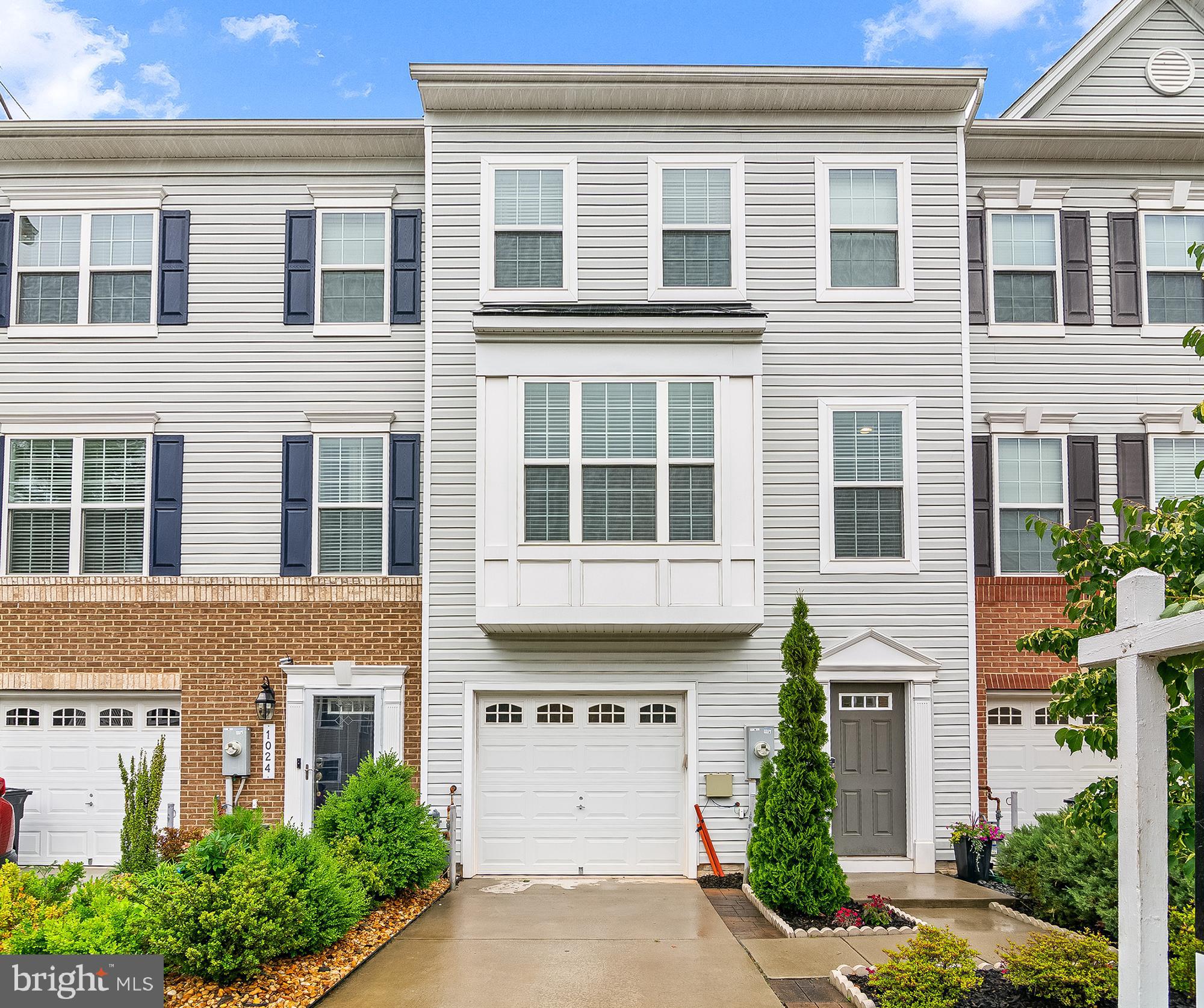 1022 Linden Drive Hanover, MD 21076 - Photo 2 of 42 a front view of a house with a yard and garage