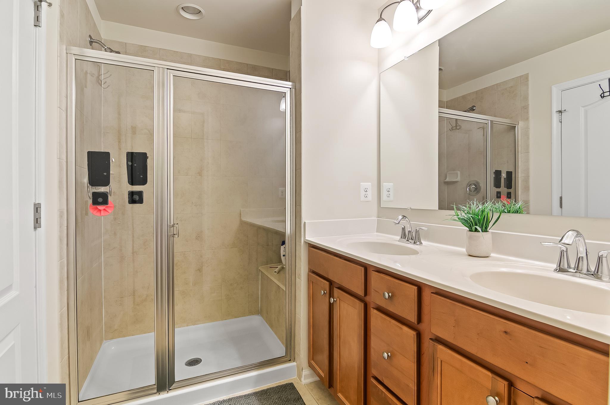 1022 Linden Drive Hanover, MD 21076 - Photo 36 of 42 a bathroom with a shower sink and mirror