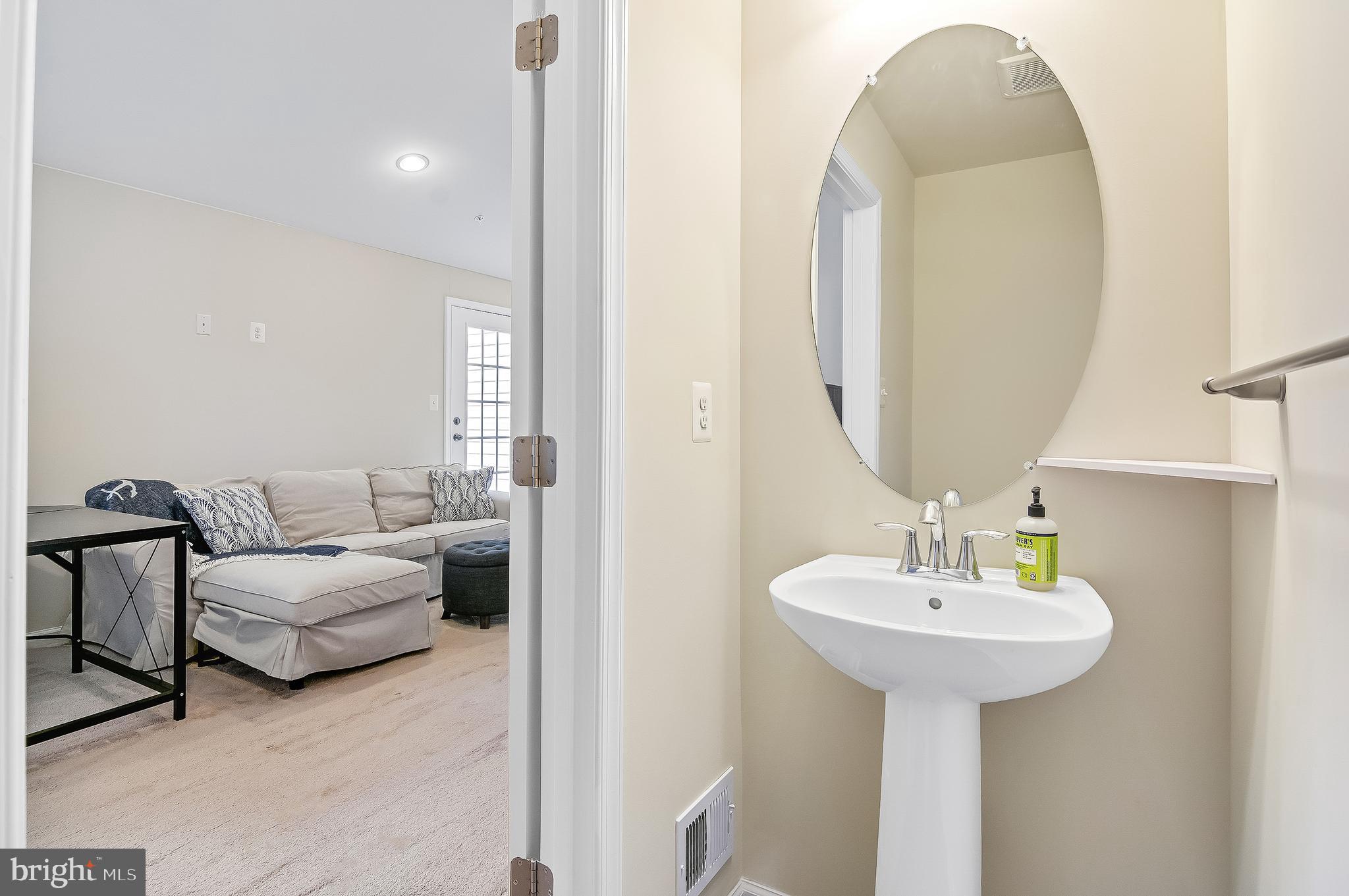 1022 Linden Drive Hanover, MD 21076 - Photo 40 of 42 a bathroom with a sink and a mirror