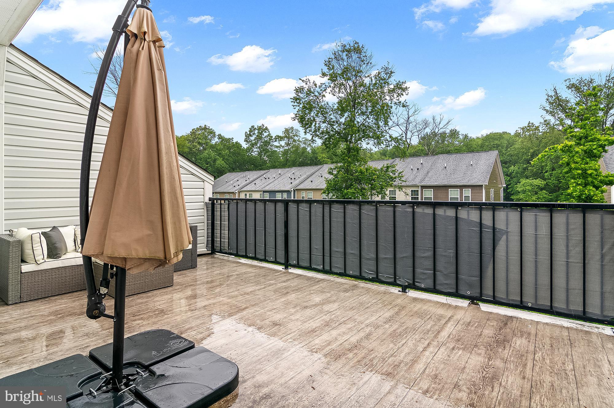 1022 Linden Drive Hanover, MD 21076 - Photo 41 of 42 a view of a backyard with floor to ceiling window and wooden fence