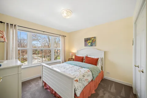 a bedroom with a large bed and a large window