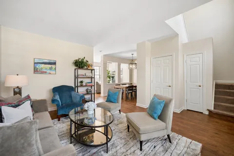 a living room with furniture and wooden floor