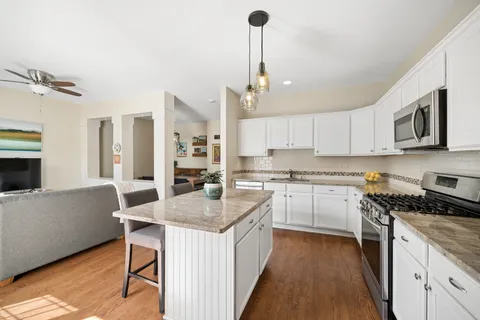 a kitchen with a sink stove and cabinets