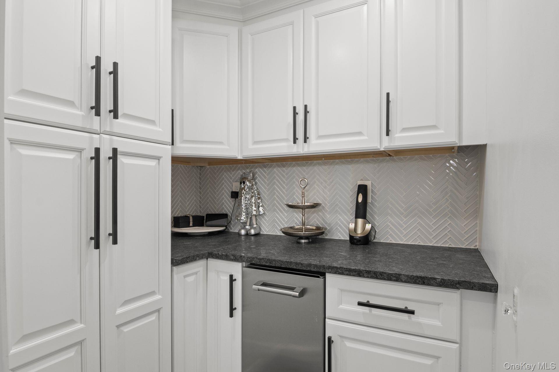 131 Fleets Cove Road Huntington, NY 11743 - Photo 11 of 41 a kitchen with granite countertop white cabinets and a sink