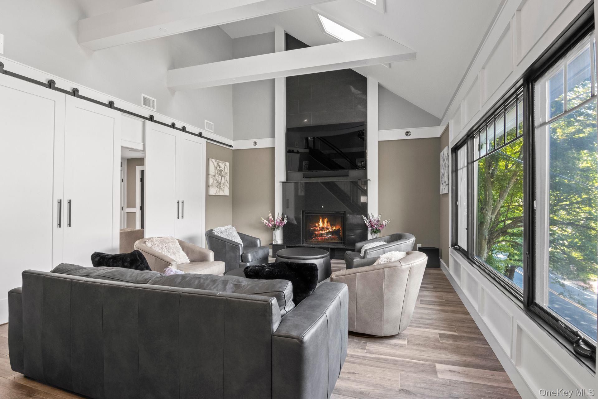 131 Fleets Cove Road Huntington, NY 11743 - Photo 17 of 41 a living room with furniture a large window and a fireplace