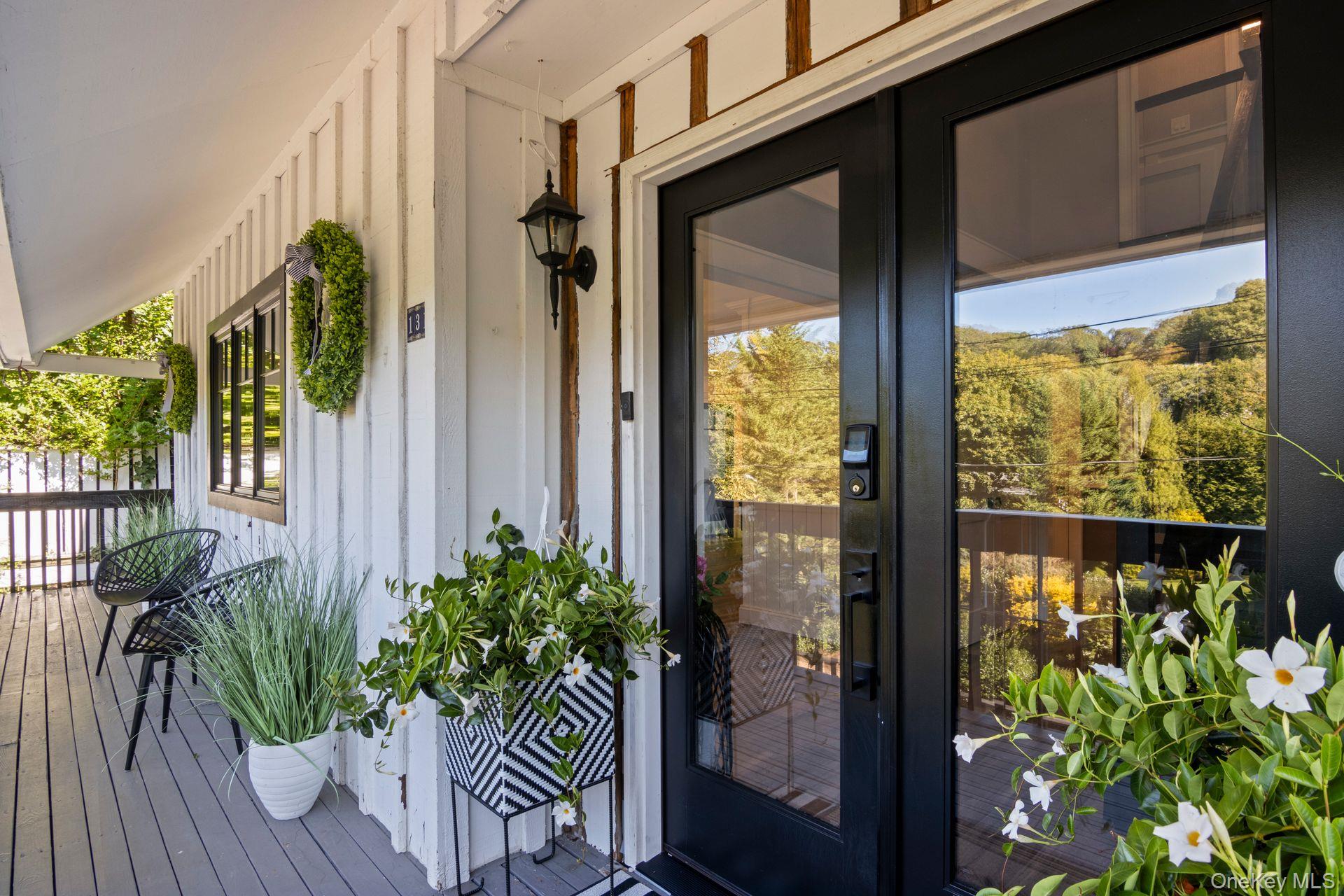 131 Fleets Cove Road Huntington, NY 11743 - Photo 2 of 41 a potted plant sitting in front of a glass door