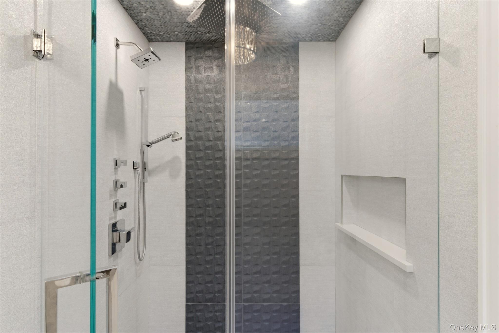 131 Fleets Cove Road Huntington, NY 11743 - Photo 28 of 41 a bathroom with a shower and a glass door