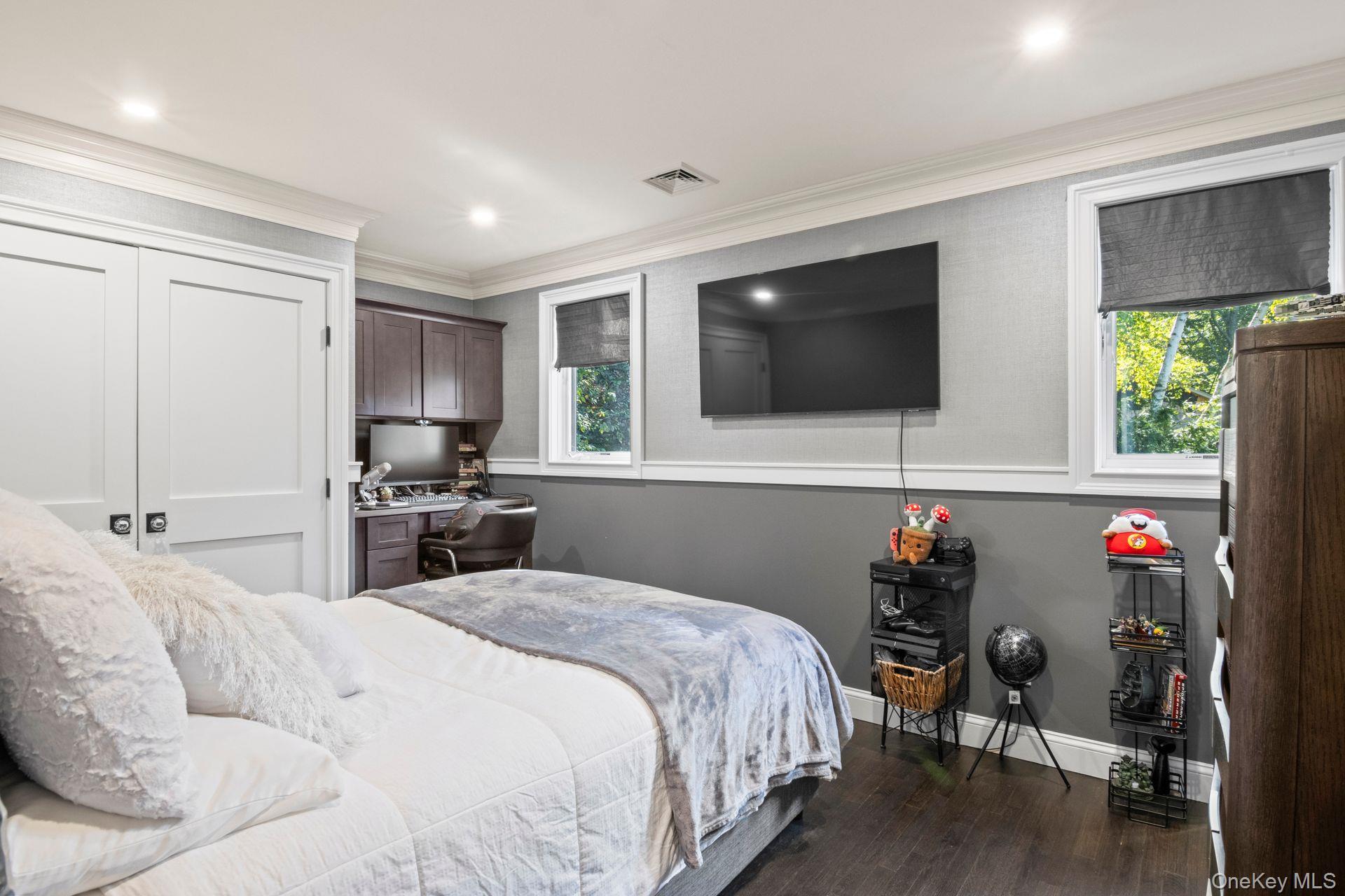 131 Fleets Cove Road Huntington, NY 11743 - Photo 29 of 41 a bedroom with a bed and a flat screen tv