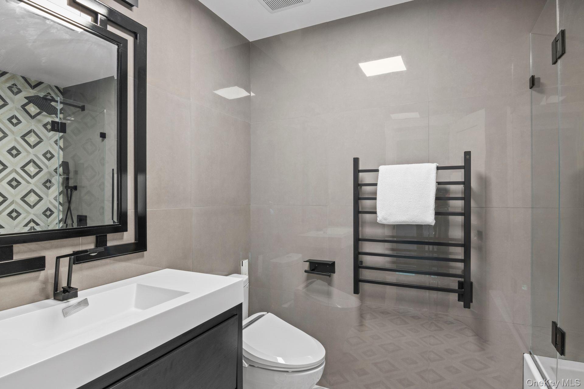 131 Fleets Cove Road Huntington, NY 11743 - Photo 31 of 41 a bathroom with a sink toilet and shower