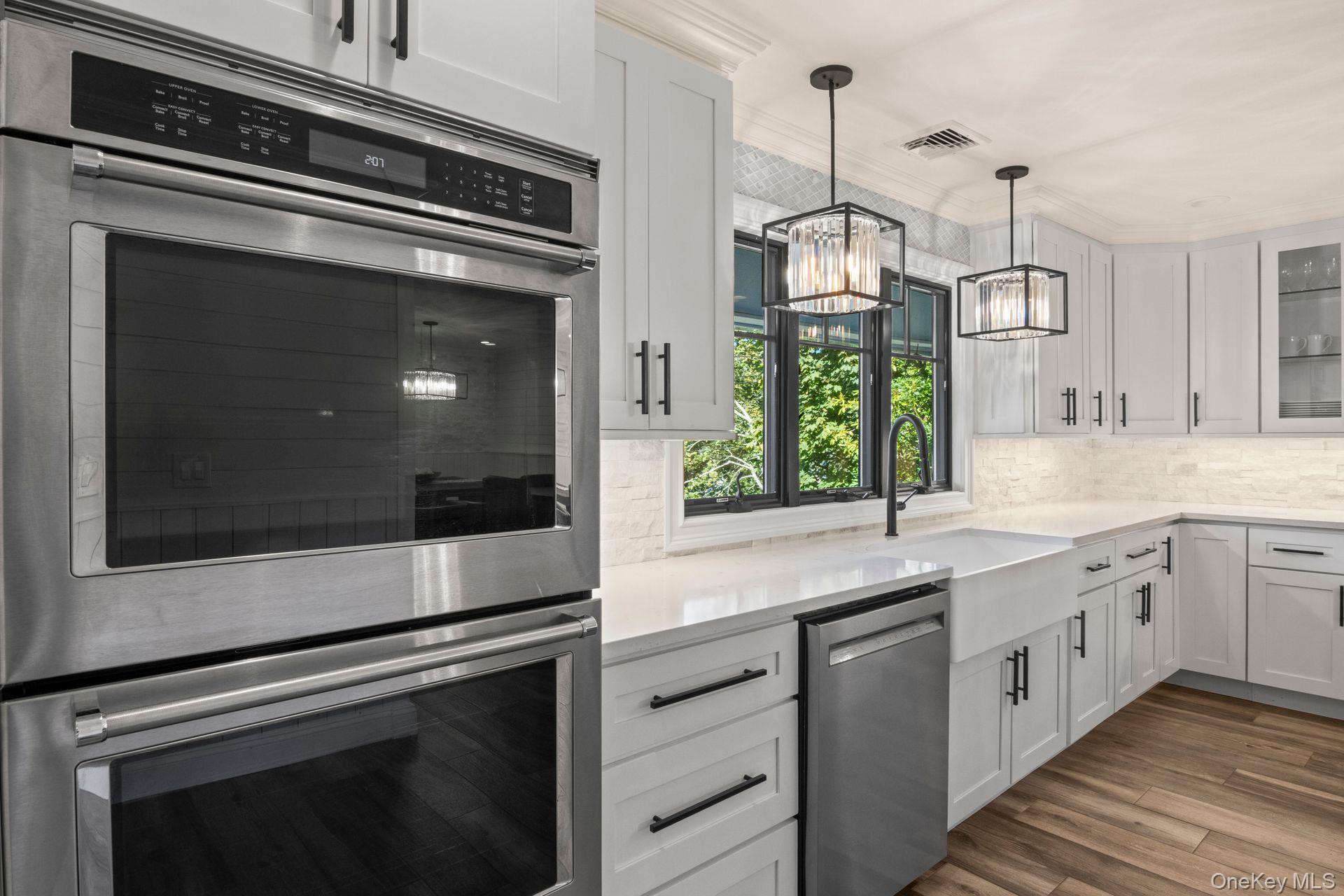 131 Fleets Cove Road Huntington, NY 11743 - Photo 8 of 41 a kitchen with stainless steel appliances white cabinets and a sink