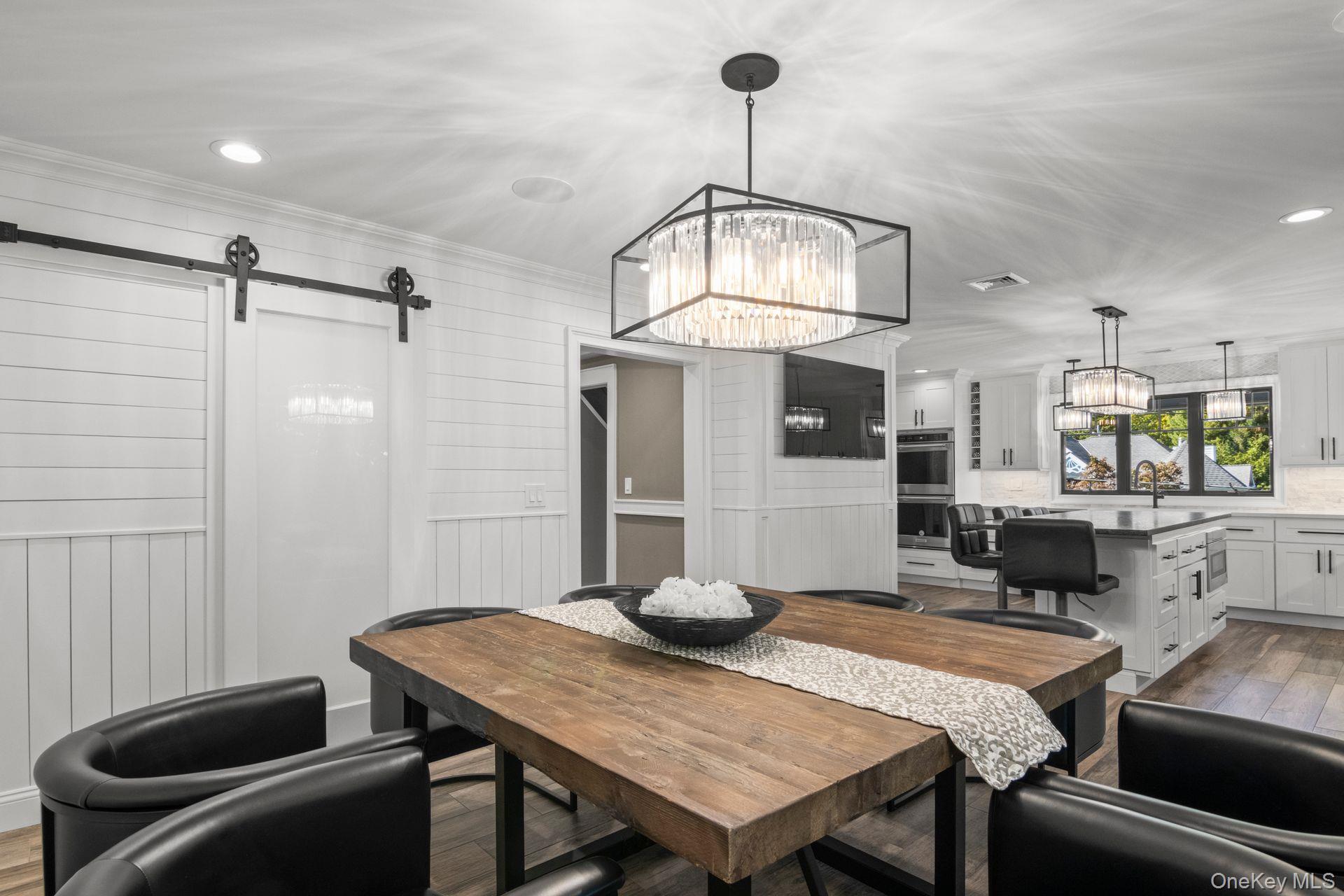 131 Fleets Cove Road Huntington, NY 11743 - Photo 9 of 41 a view of a dining room with furniture wooden floor and chandelier
