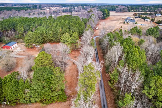 an aerial view of a house with a yard and lake view