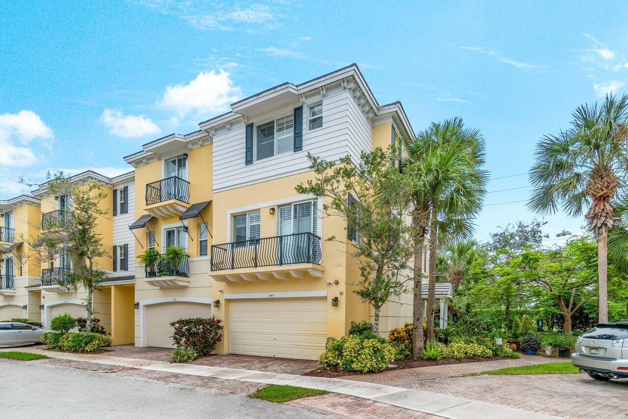 547 Northwest 35th Place Boca Raton, FL 33431 - Photo 1 of 37 a front view of a house with a yard and garage