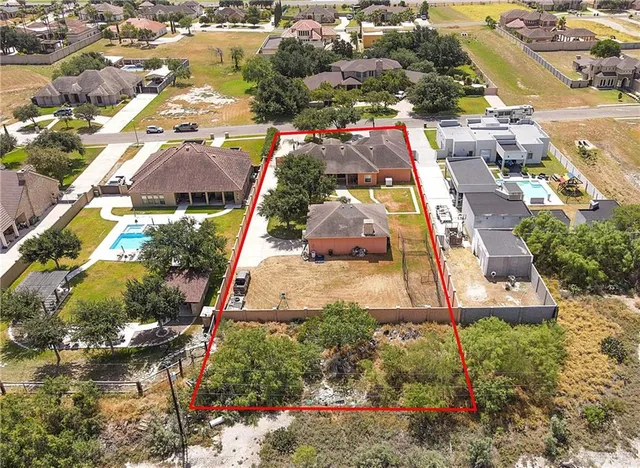 an aerial view of residential houses with outdoor space