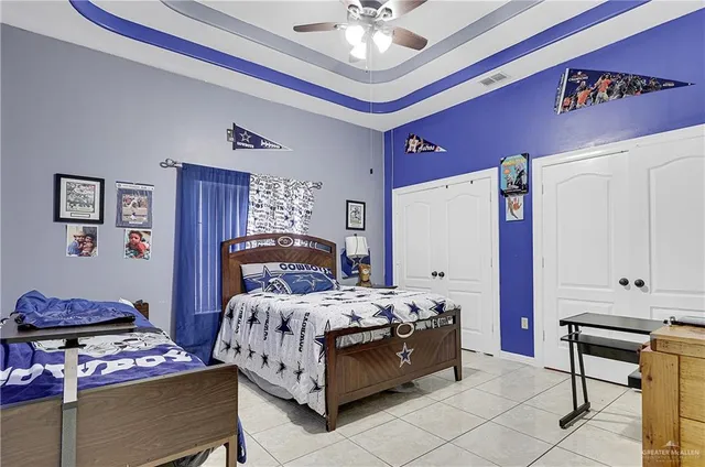 a bedroom with a bed and a chandelier