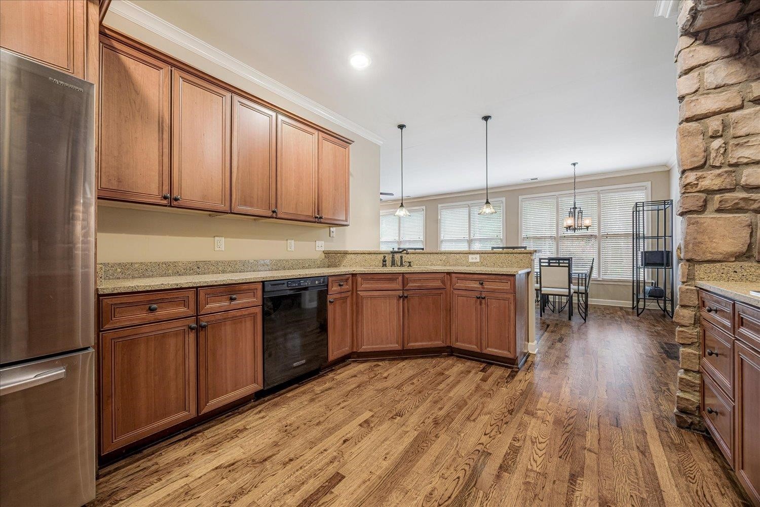 4597 Whisper Spring Drive Collierville, TN 38017 - Photo 7 of 39 a kitchen with stainless steel appliances granite countertop wooden cabinets a refrigerator a sink a stove and a refrigerator