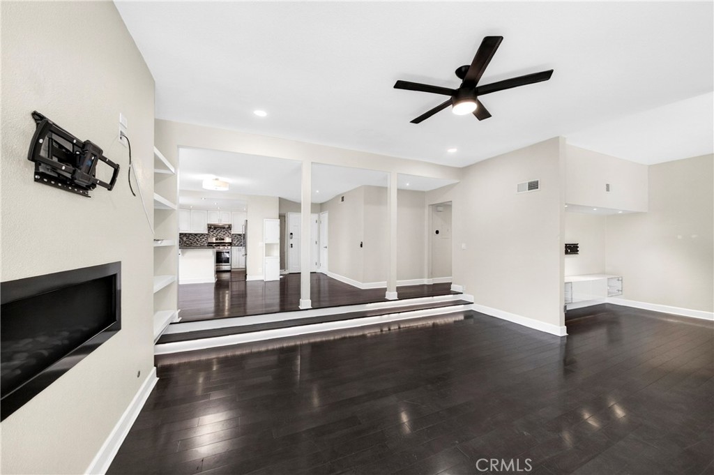 9 Madrona Irvine, CA 92612 - Photo 14 of 38 a view of a livingroom with a fireplace a ceiling fan and wooden floor