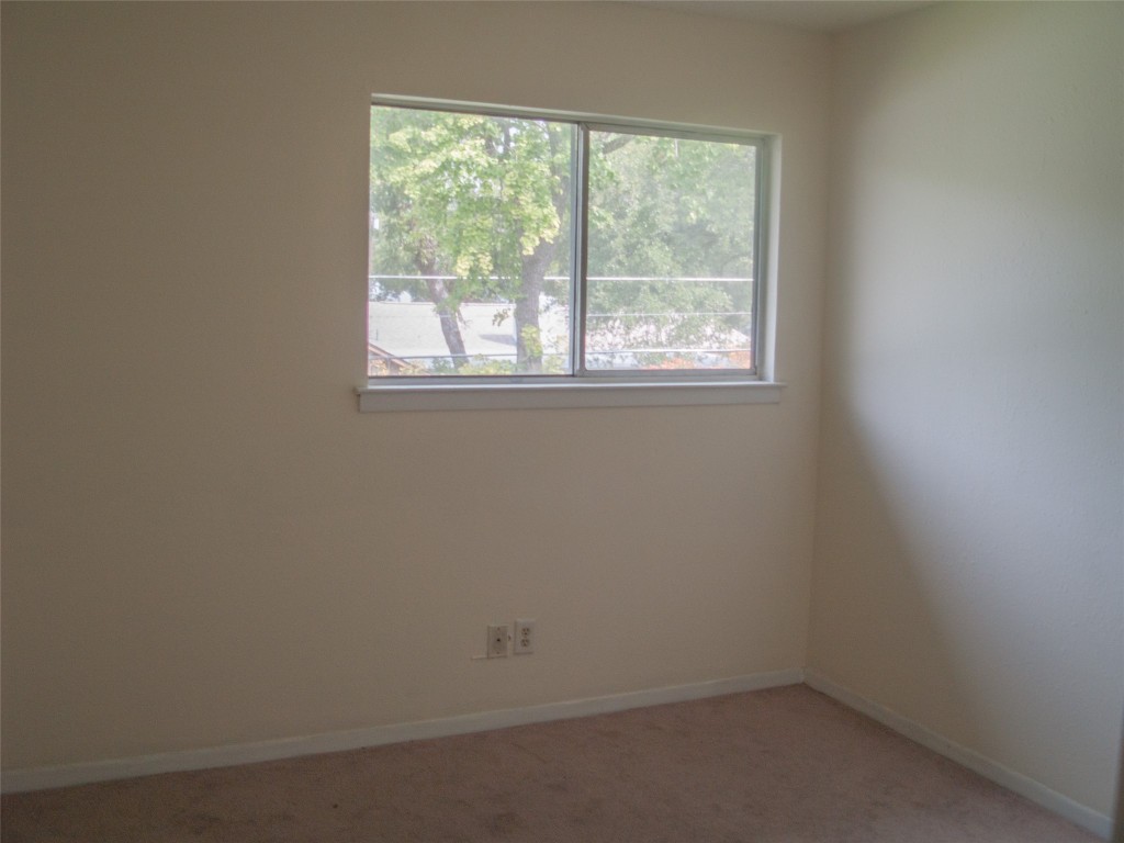 1745 Wooten Park Drive, Unit 101 Austin, TX 78757 - Photo 18 of 19 an empty room with a window