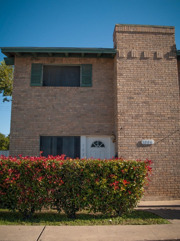 1745 Wooten Park Drive, Unit 101 Austin, TX 78757 - Photo 2 of 19 a view of a house with a garden