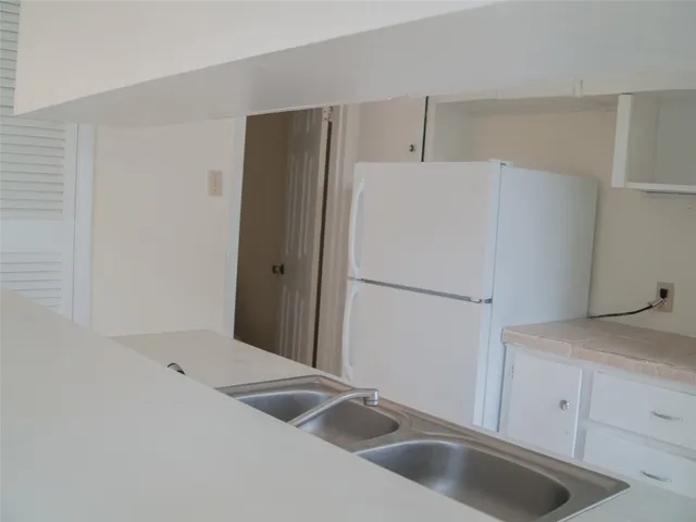 a kitchen with a sink and refrigerator