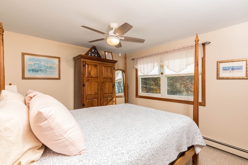 280 Stone Street Gardner, MA 01440 - Photo 15 of 28 a bedroom with a large bed and a chandelier