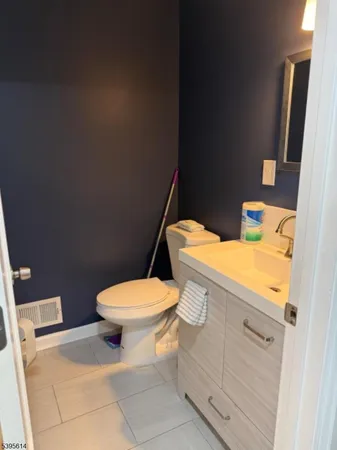 a white toilet sitting next to a bathroom sink